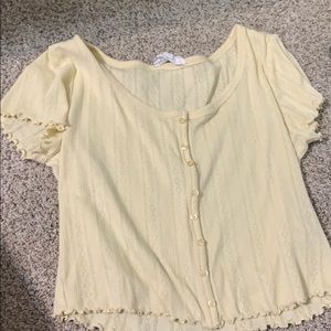 Cropped yellow shirt with buttons and designs